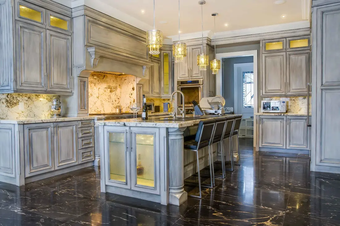 Luxurious kitchen with marble counters and elegant lighting