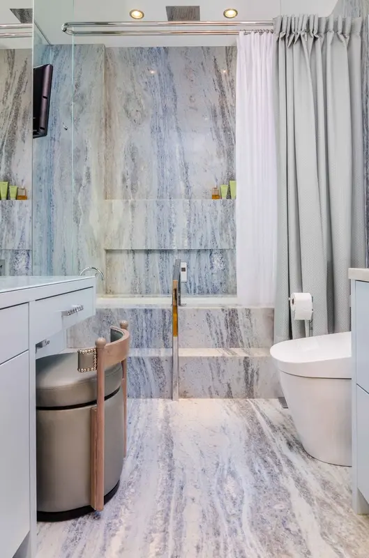 Modern bathroom with marble surfaces and white fixtures